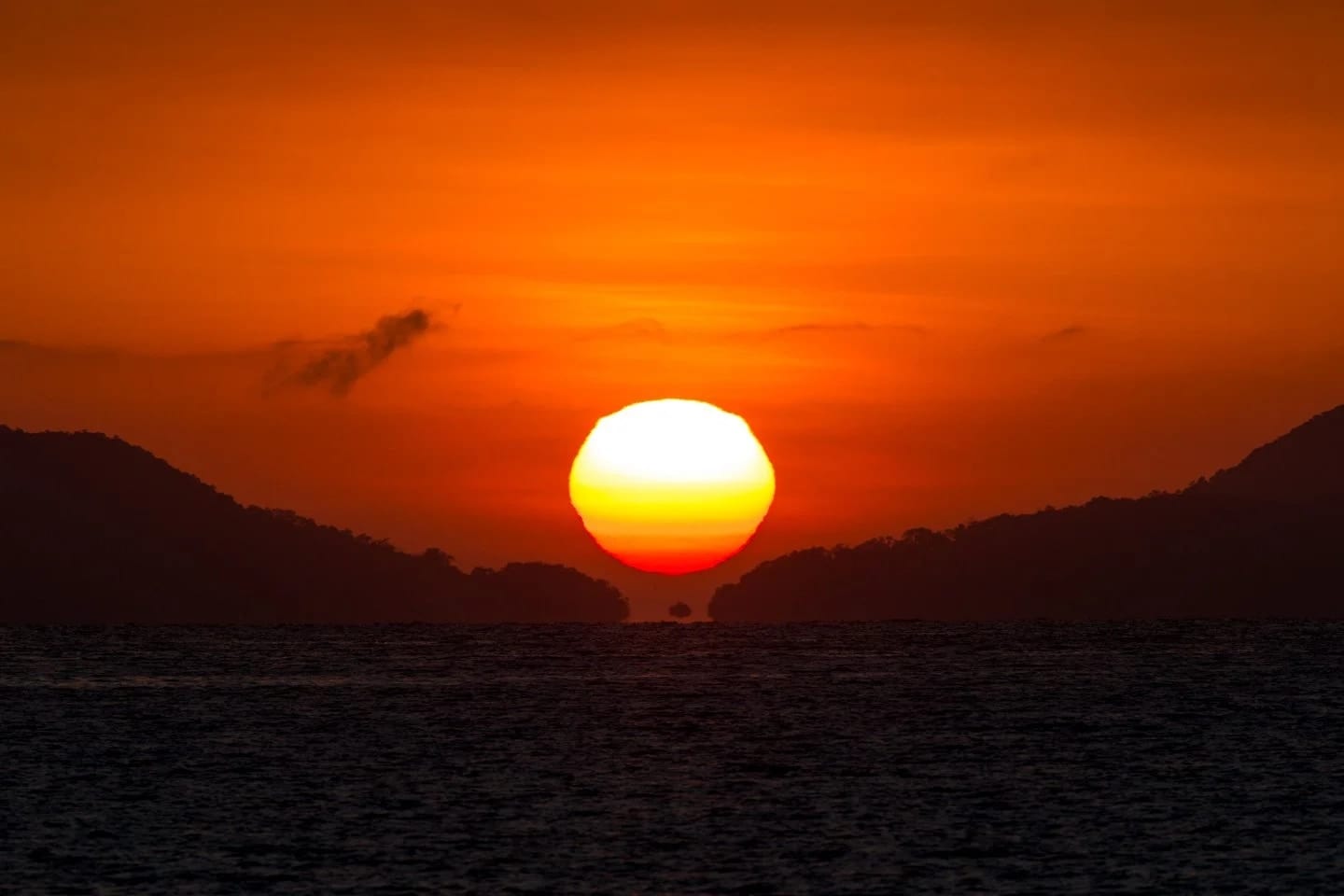 Fata Morgana, fine art photograph by Bruno Boni. The sun rises over the Lagoa Azul channel, on Ilha Grande, perfectly aligned with the corridor between Ilha dos Macacos…